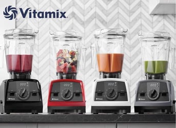 4 blenders sitting in a kitchen