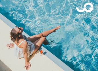 Woman sitting by a pool