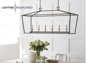 Square chandelier hanging over table