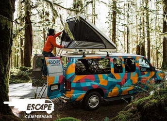 Person setting up popup tent on top of campervan in the woods