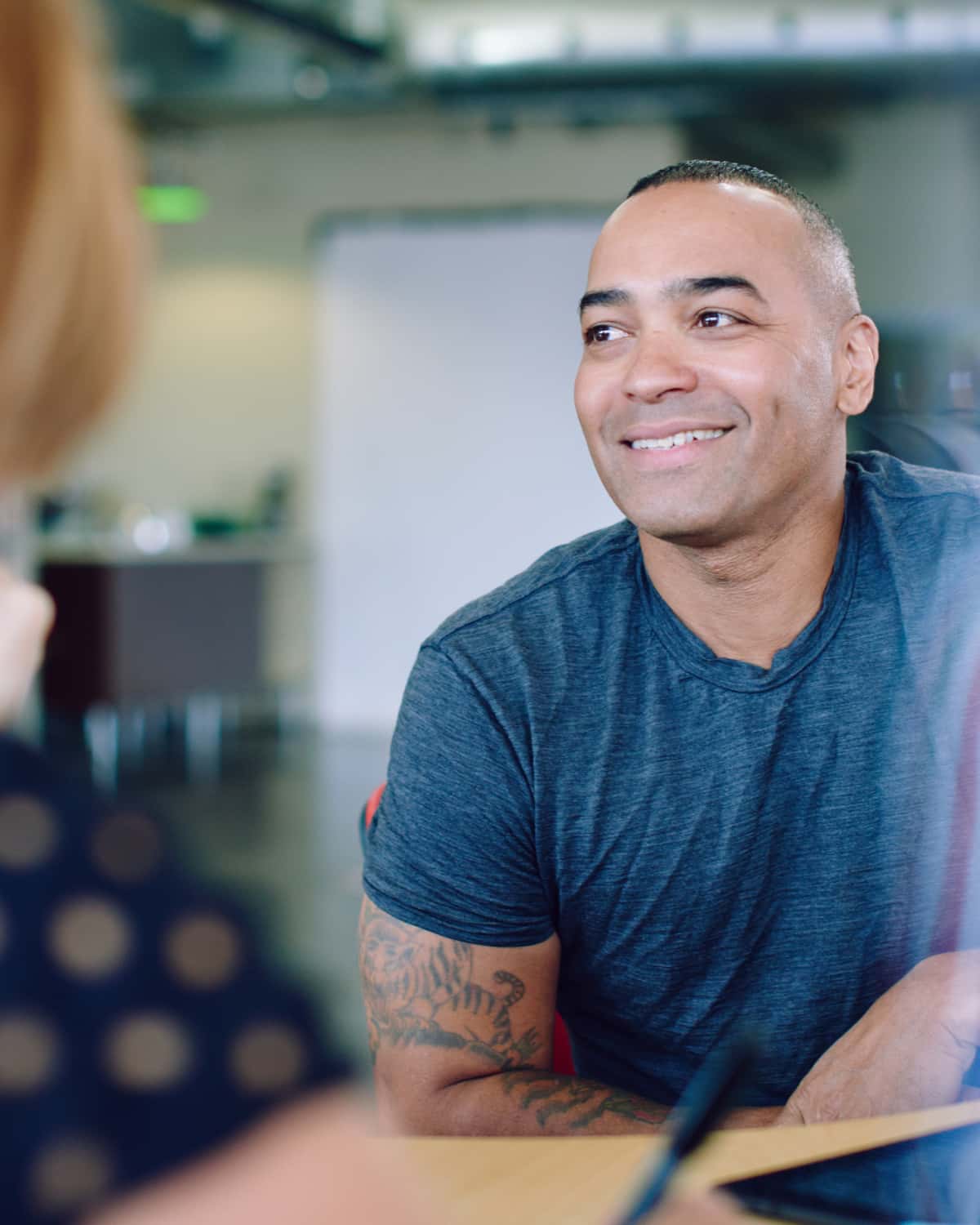 Man smiling while having conversation. 