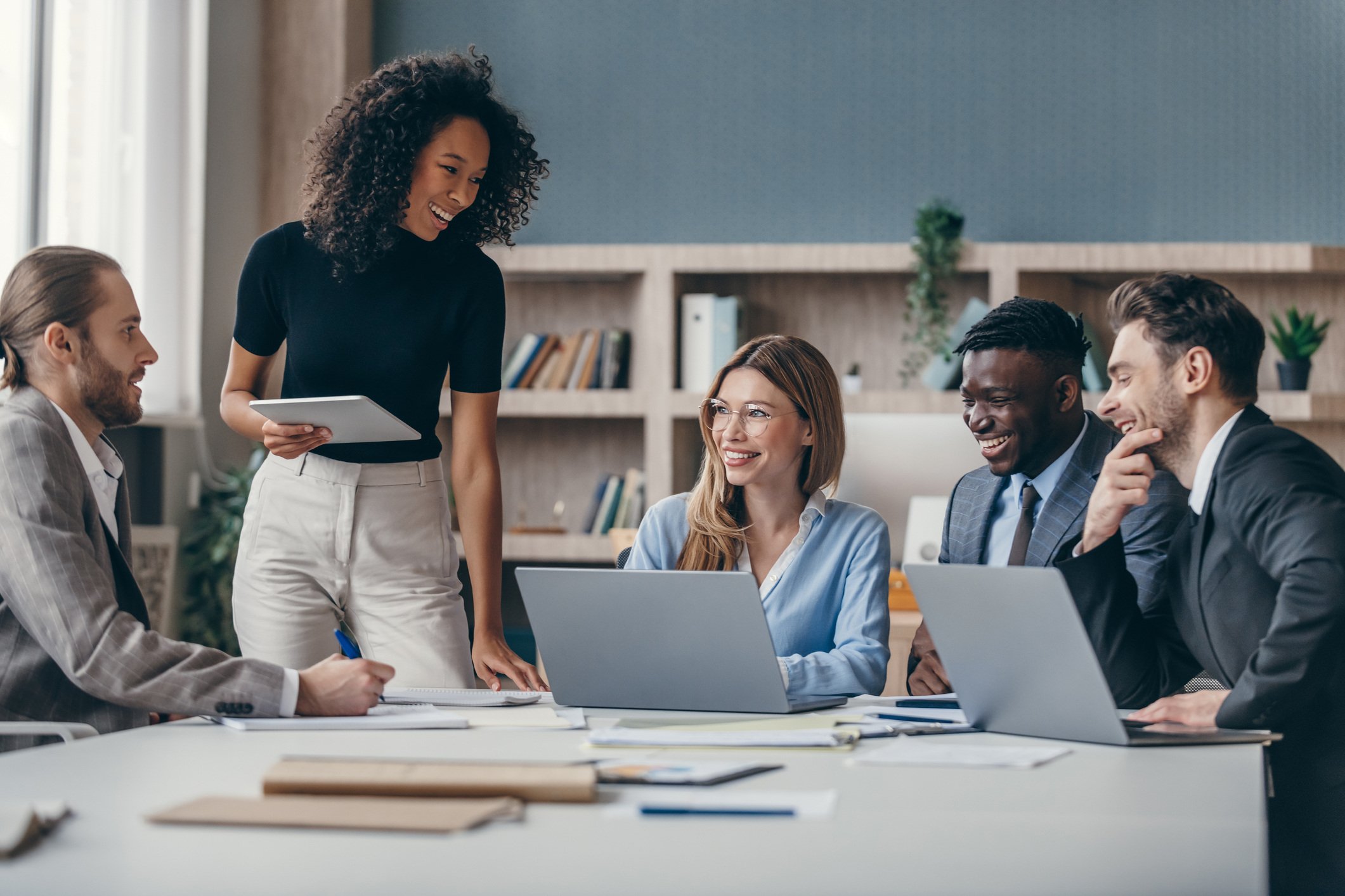 People standing around a desk working together