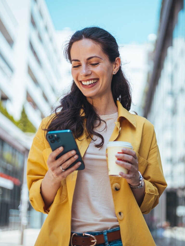 woman-walking-on-the-sidewalk-at-urban-setting-and-talking-on-the-phone.